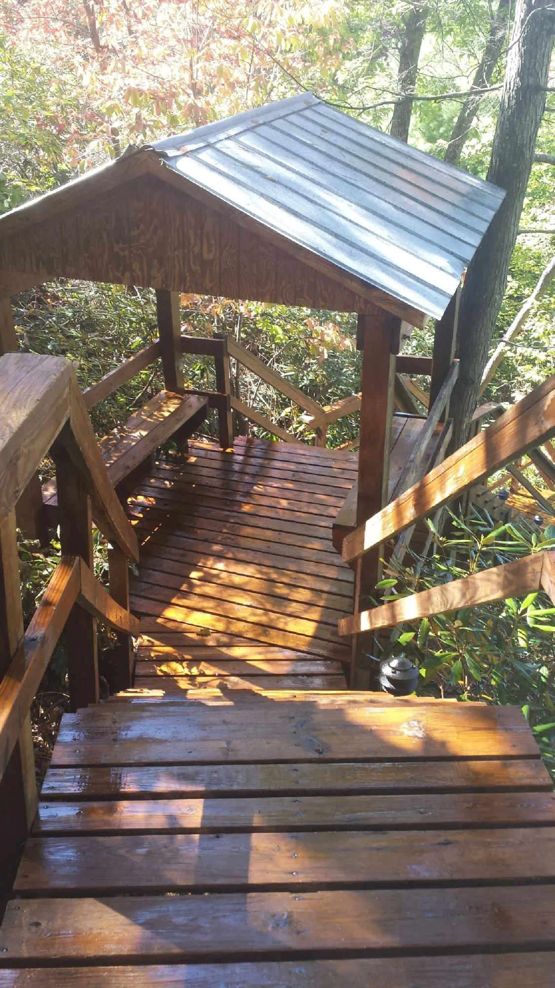 Freshly stained wood walkway and covered shelter with a metal roof in Ottine